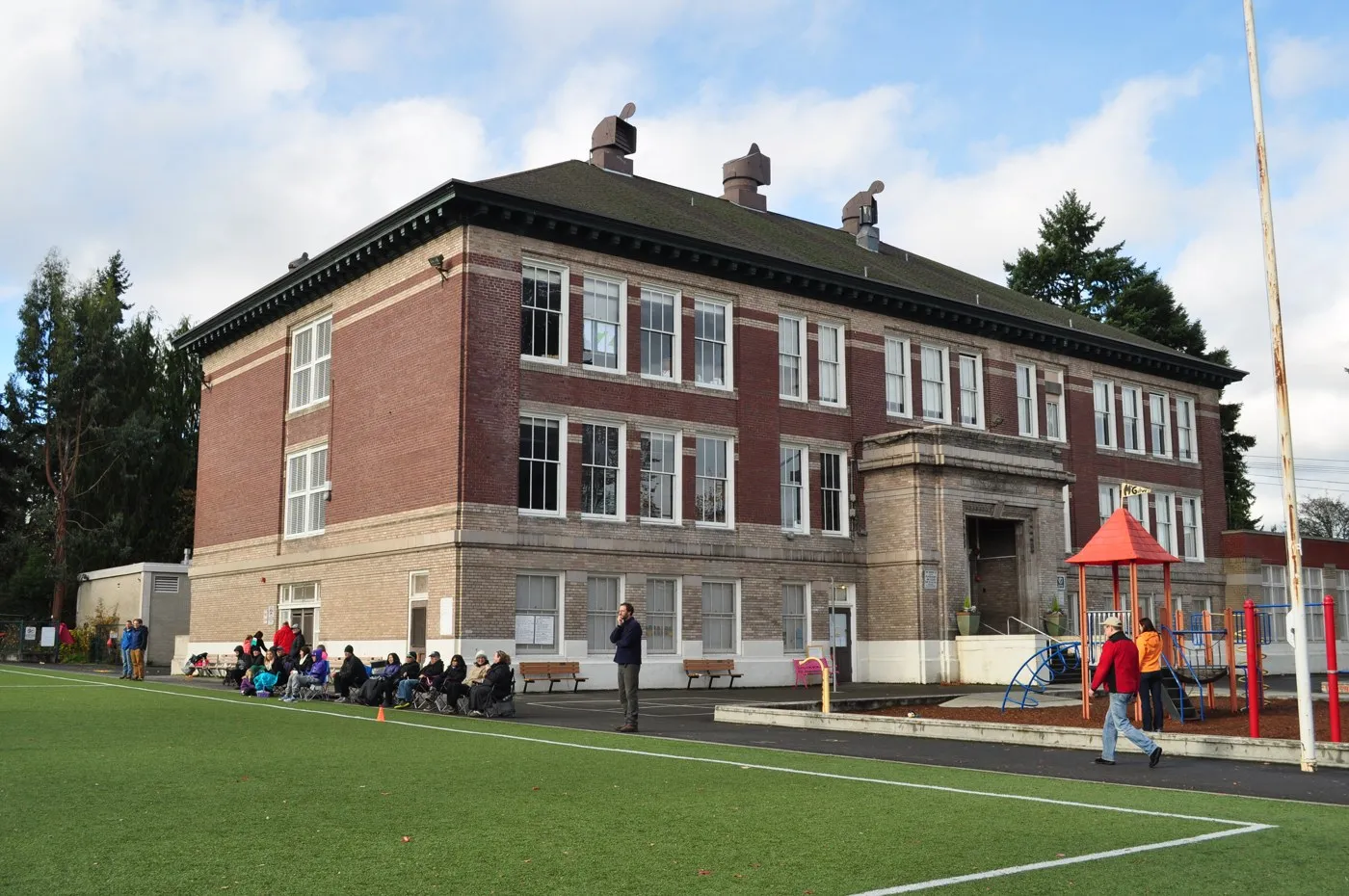 McGilvra’s red-brick school building, playground and field, photographed in 2015